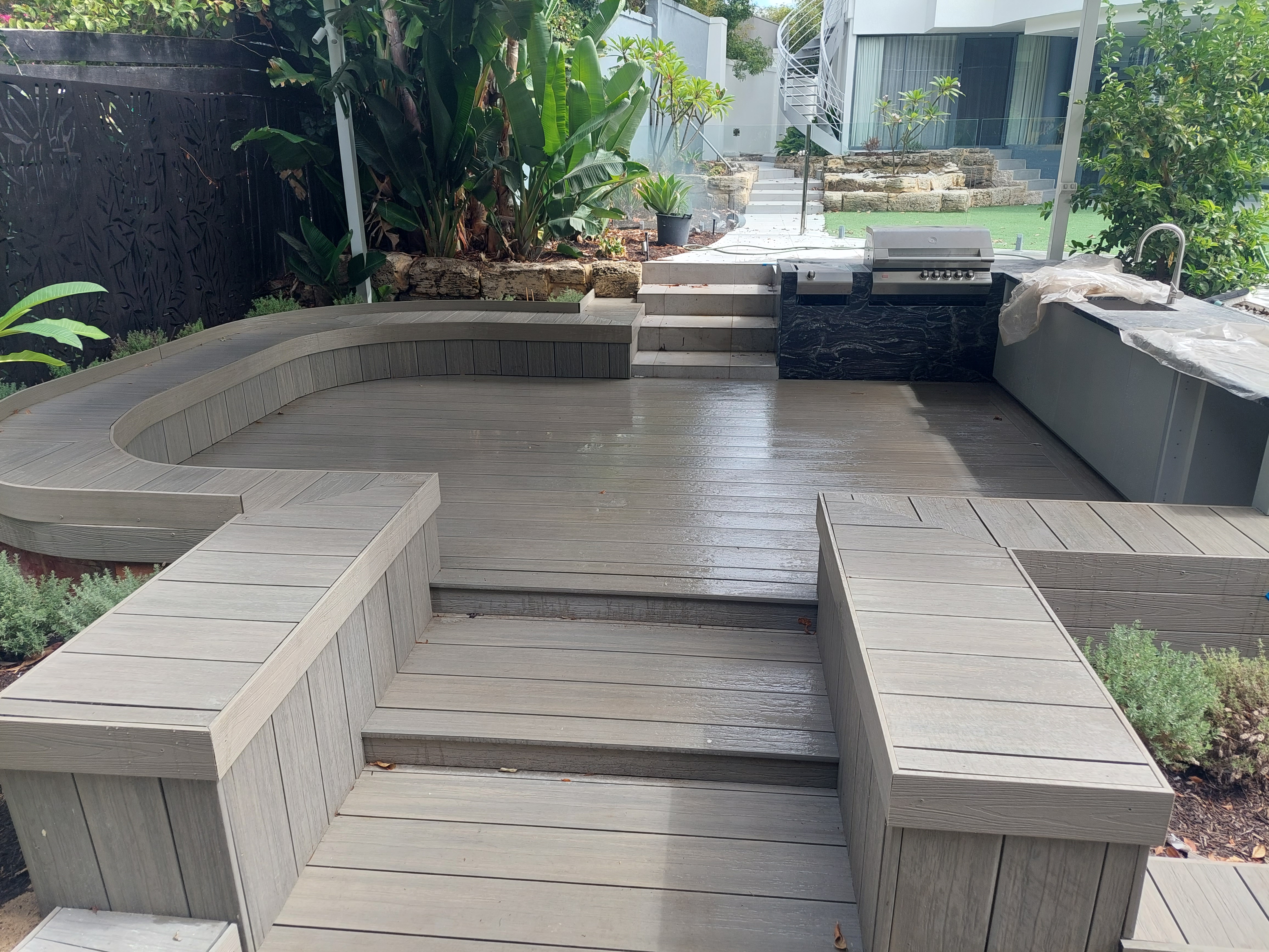 Multi-level curved deck with outdoor kitchen — SM Design & Build